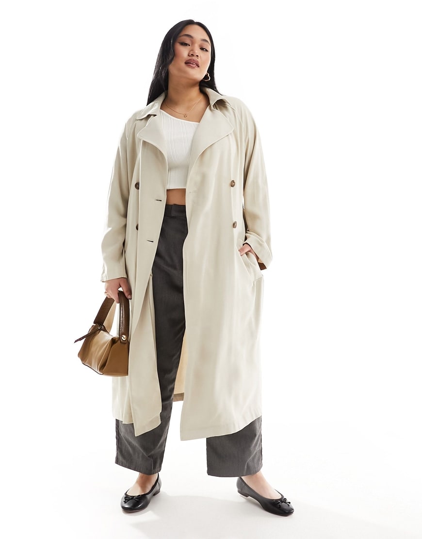 Woman wearing light beige long trench coat