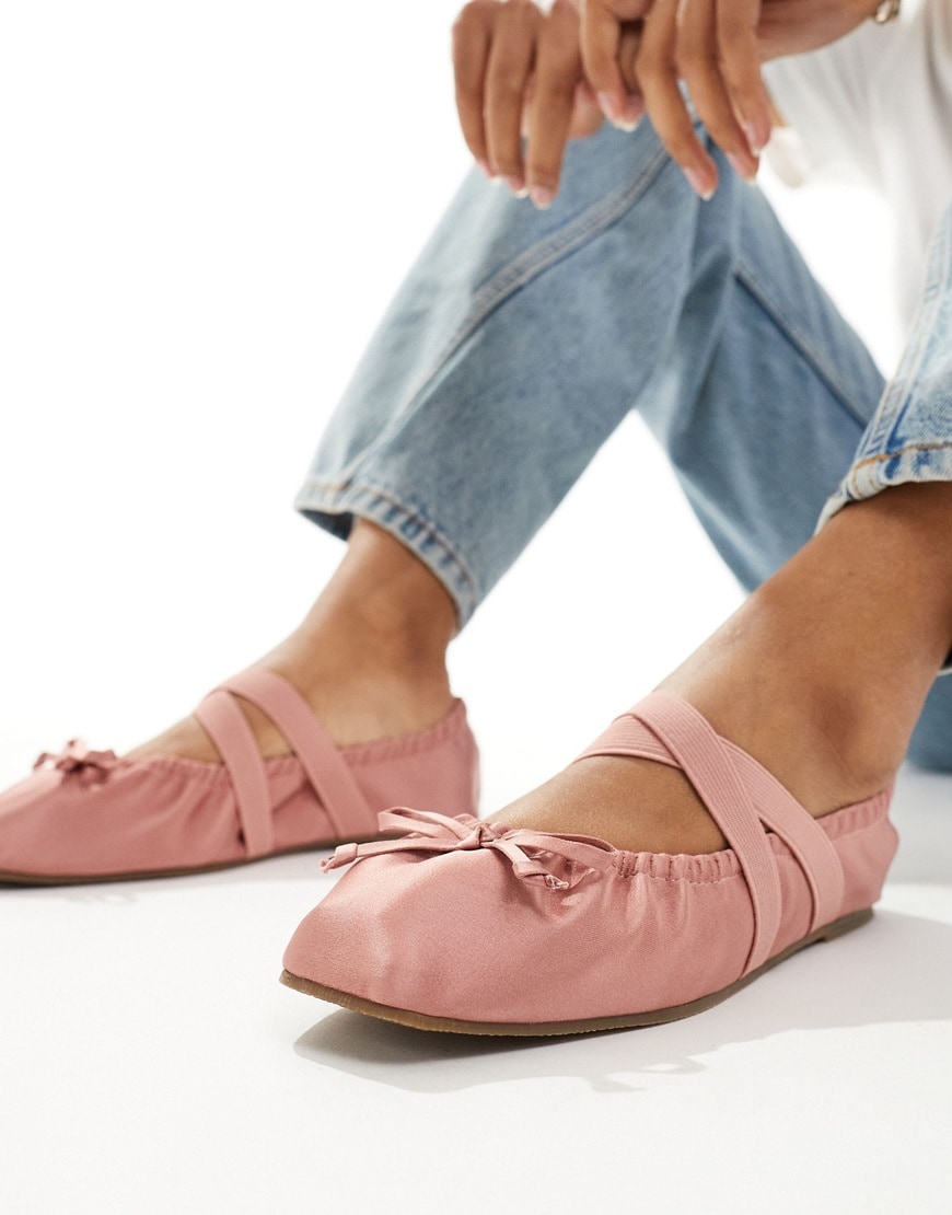 Pink satin ballet pumps and blue wide-leg jeans