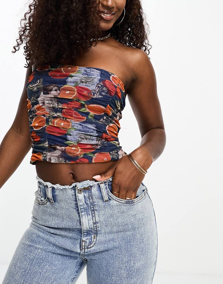 A woman wearing a blue ruched fruit print top | ASOS Style Feed