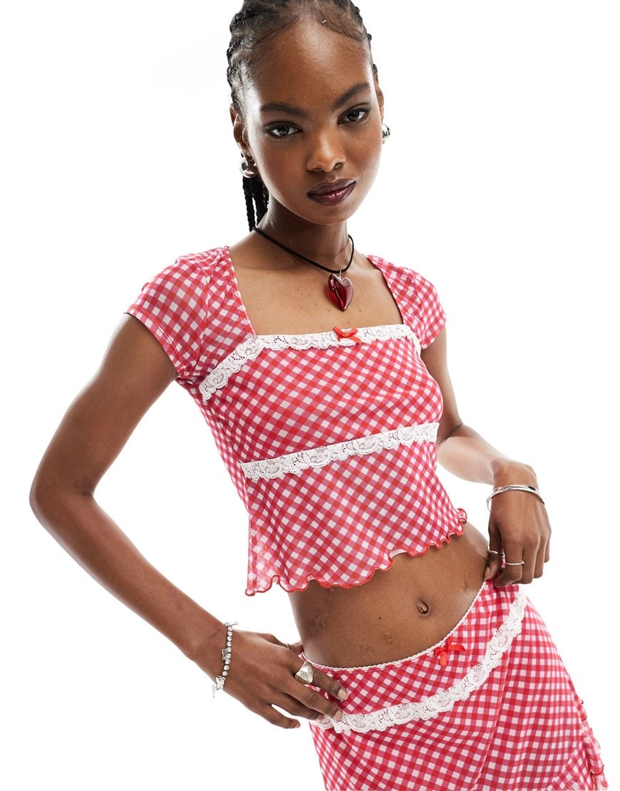 Woman wearing red gingham shirt