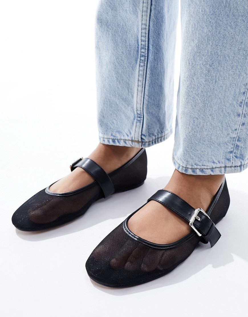 Black mesh ballet flats with blue jeans
