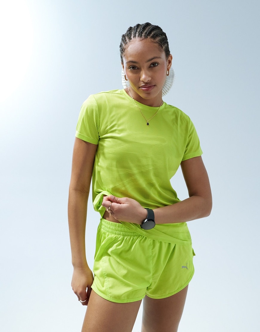 Woman wearing Puma bright neon green top and shorts