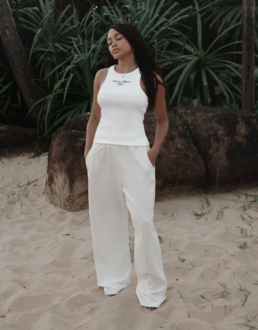 Loz Vassallo wearing a white tank top and ecru joggers