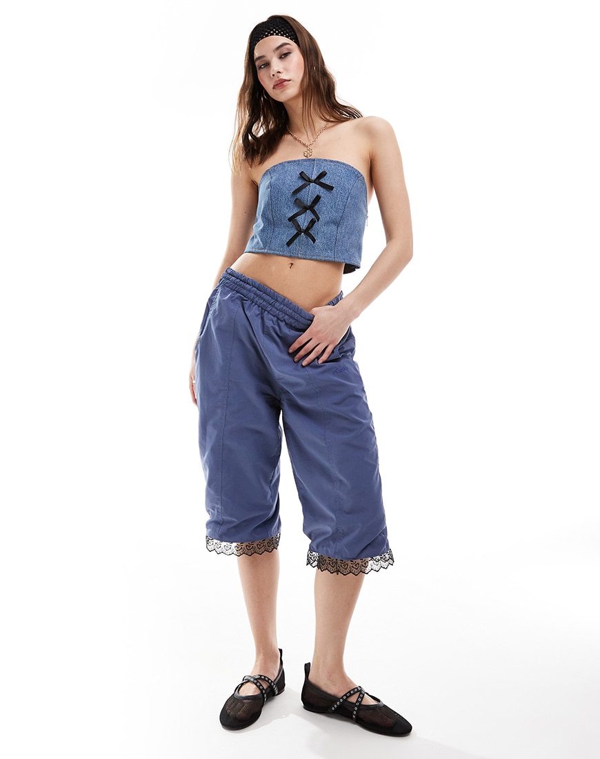 Woman wearing denim capris and bandeau with lace trim detail