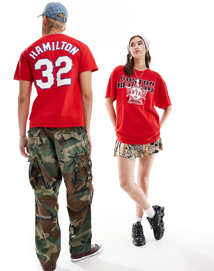 Woman wearing bright red slogan t-shirt with man wearing same t-shirt next to her