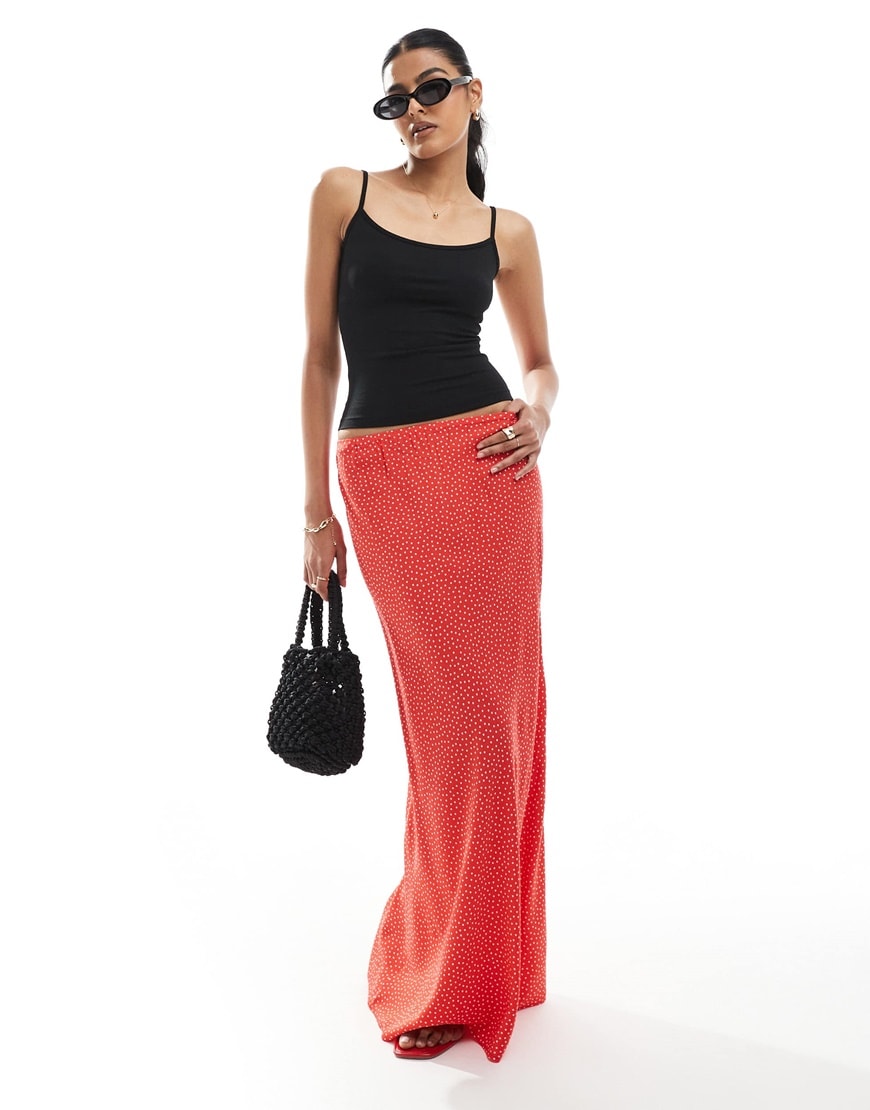 A model wearing a red polka dot maxi skirt