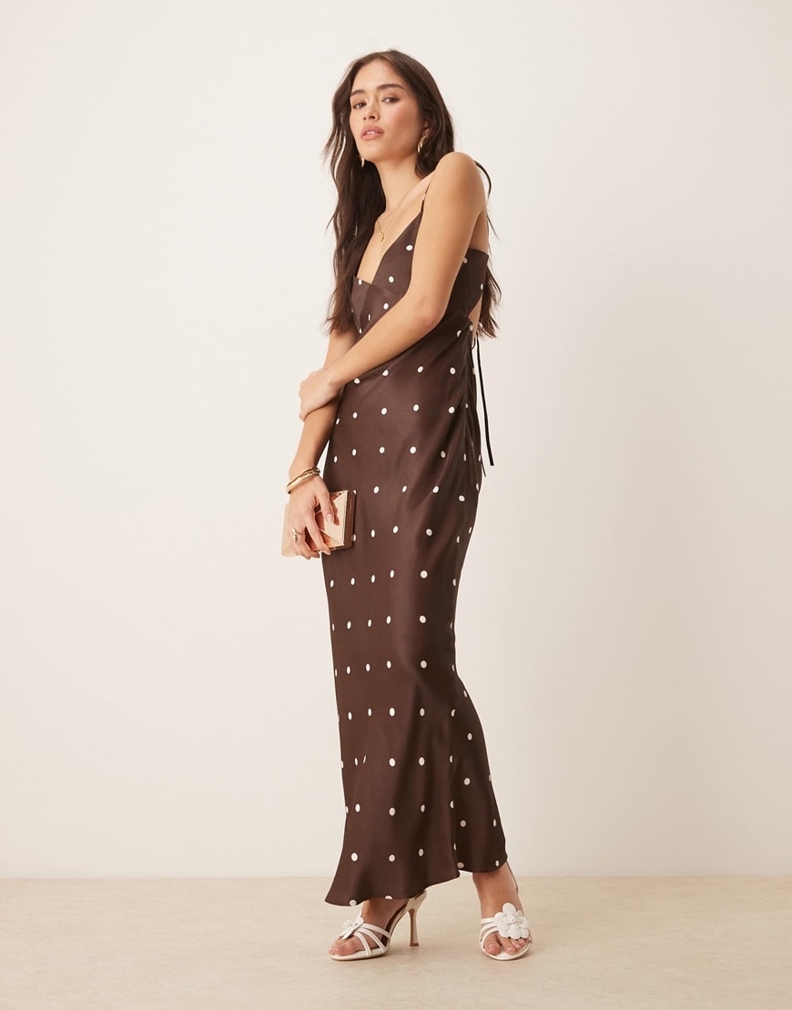 A woman wearing a brown polka dot dress
