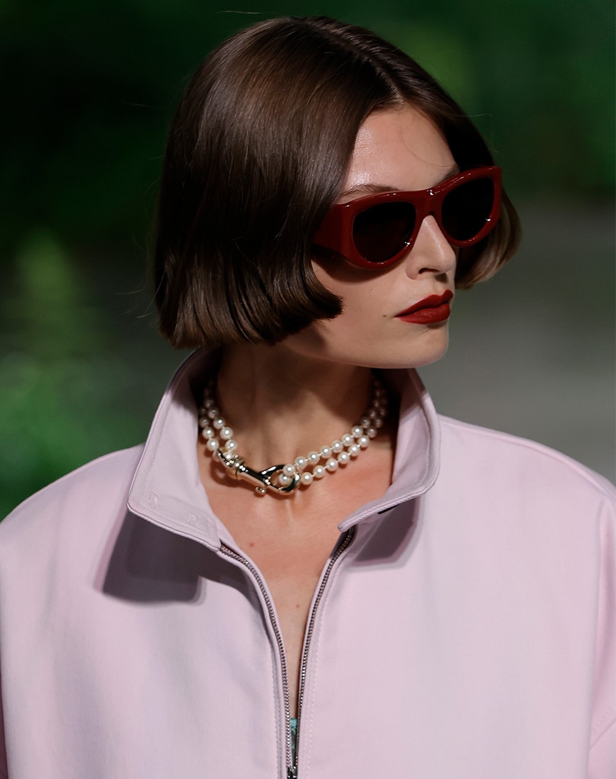 Woman wearing black sunglasses with red rims