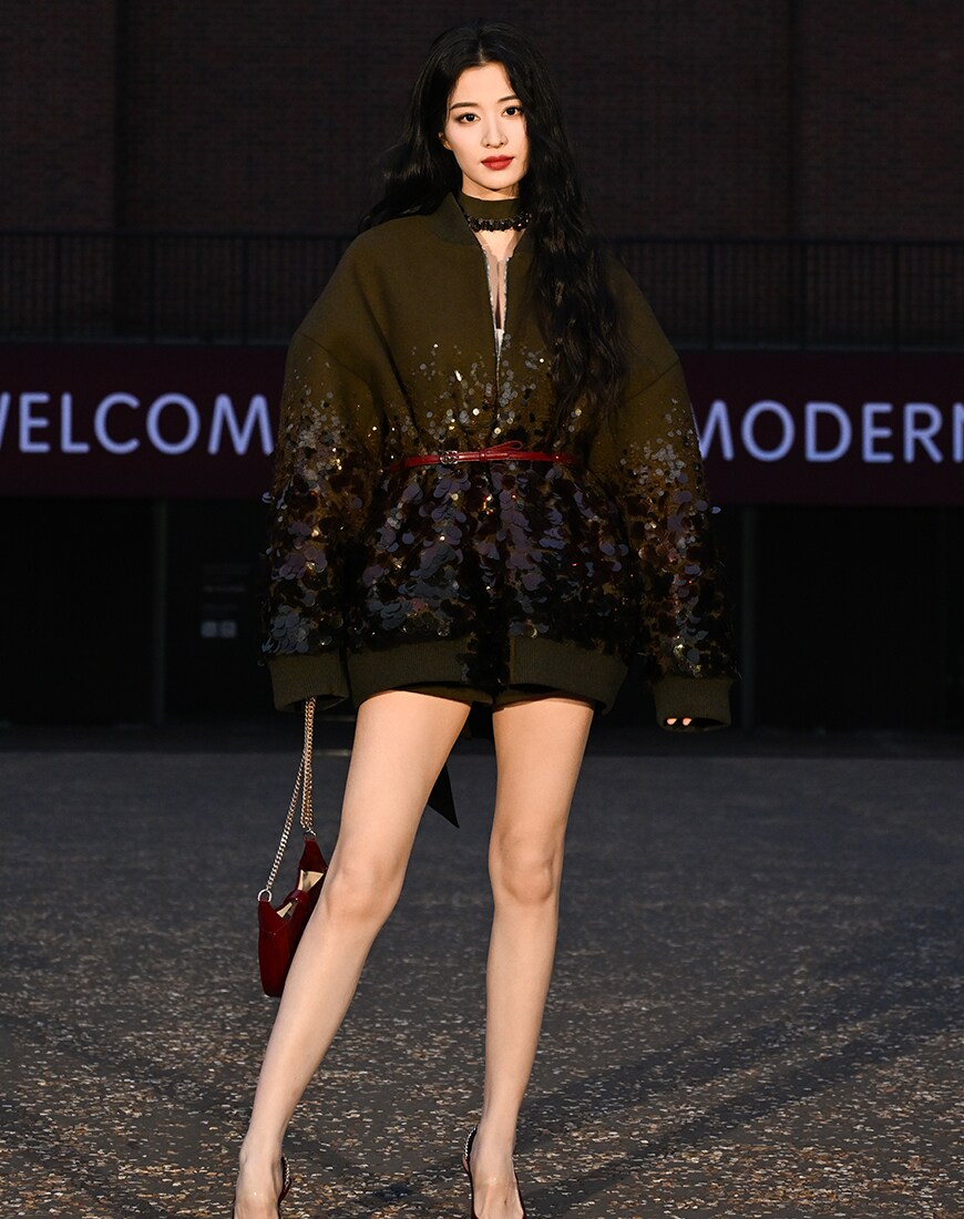 Wang Churan wearing Gucci oversized jacket with bag and heels