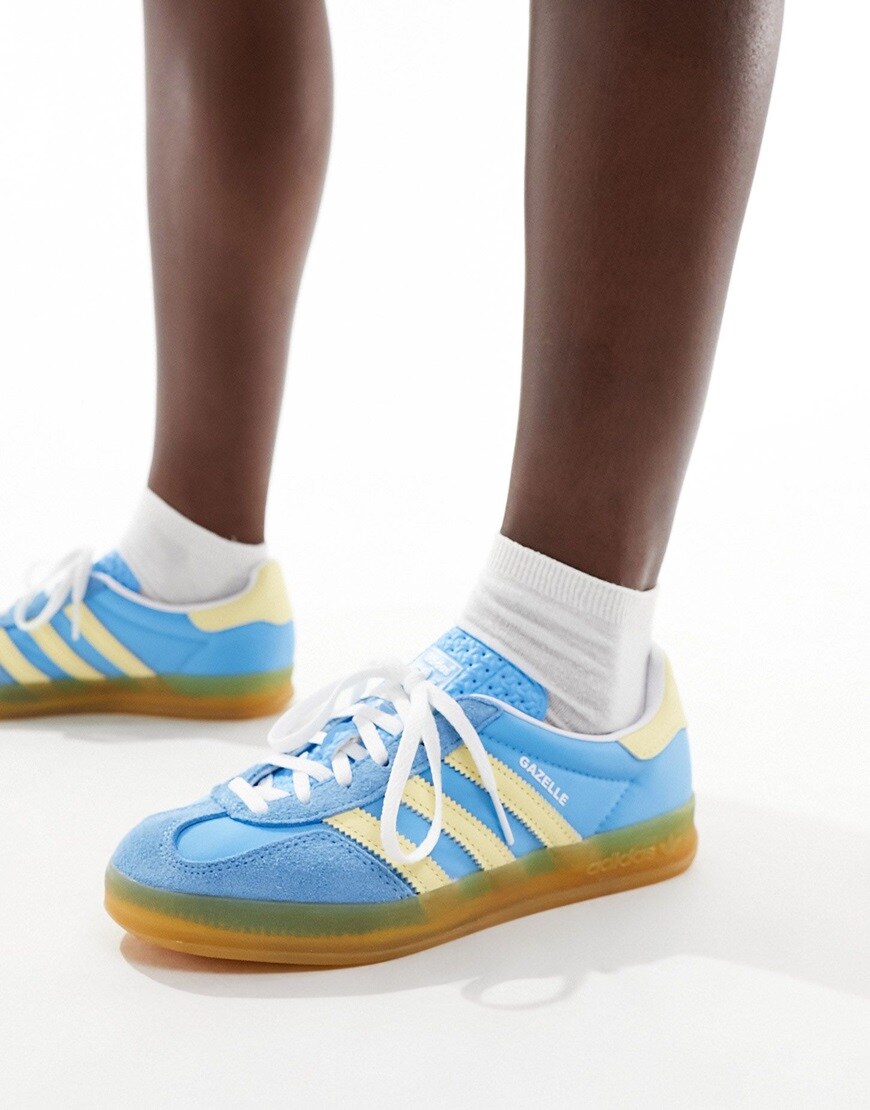 Person wearing adidas Originals gum sole Gazelle Indoor trainers in blue and yellow