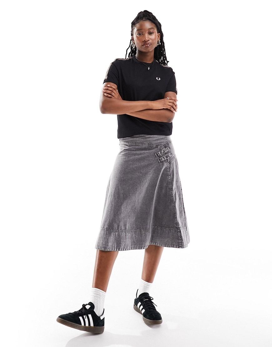 Woman in top and denim skirt