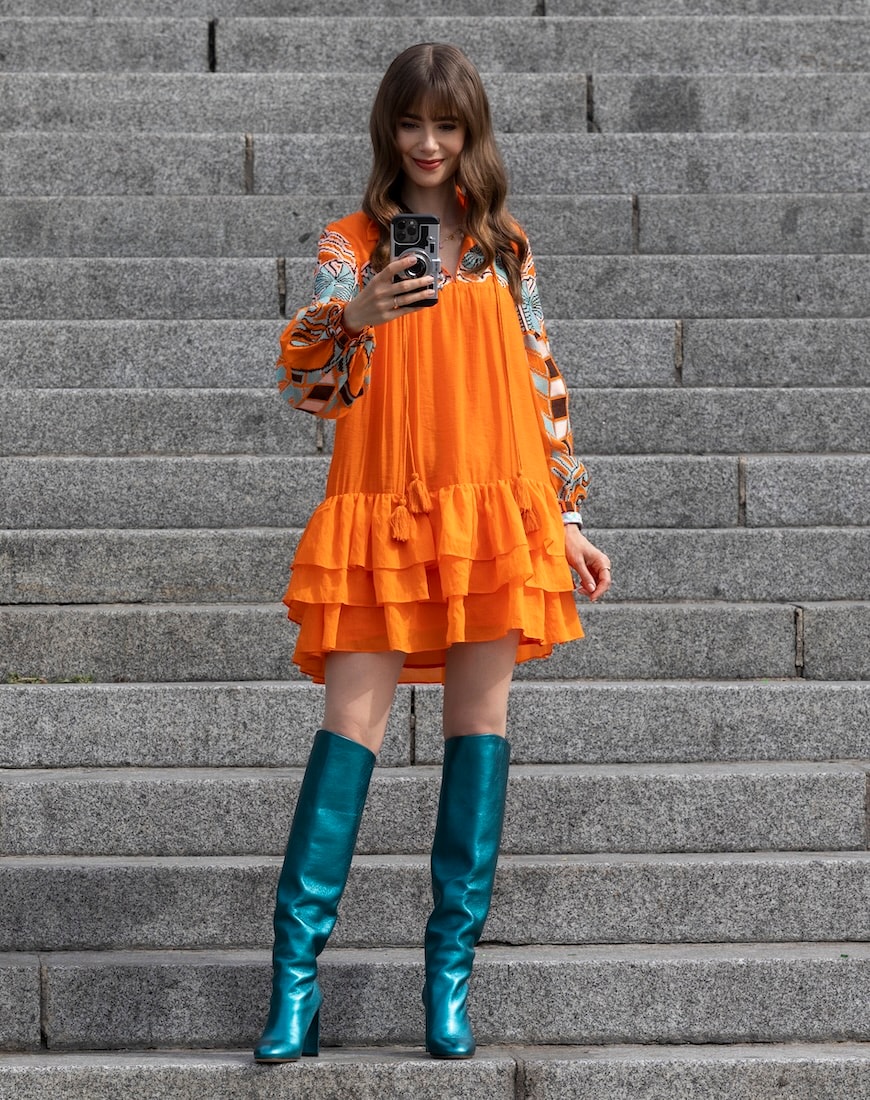 Emily in a bright orange and teal outfit