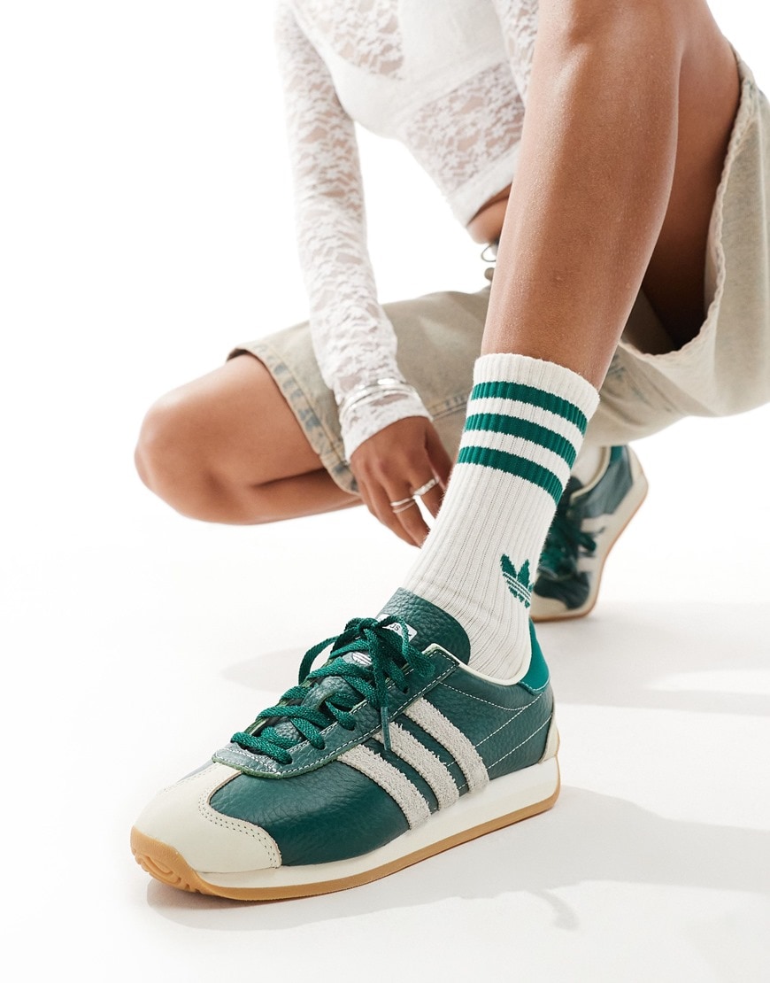A model wearing adidas Originals Country OG trainers in green and white | ASOS Style Feed