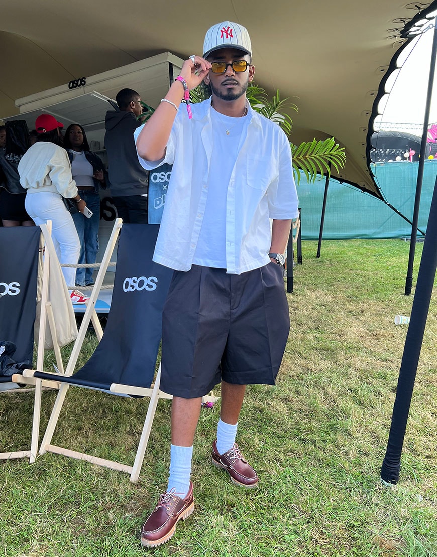 Moe in tailored shorts and shirt, holding sunglasses. | ASOS Style Feed
