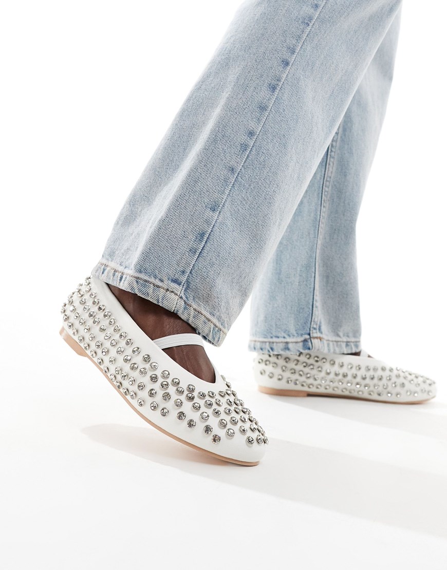 A woman wearing white ballet flats with silver studs | ASOS Style Feed