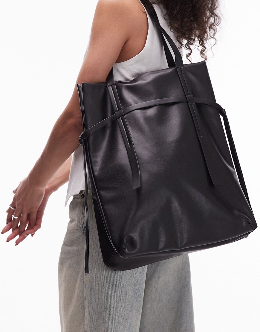 A woman wearing a black leather tote bag | ASOS Style Feed