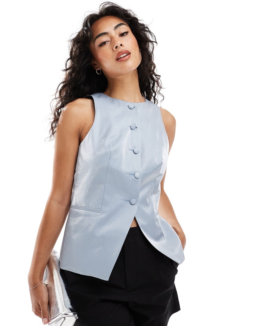 A woman wearing a metallic blue waistcoat | ASOS Style Feed