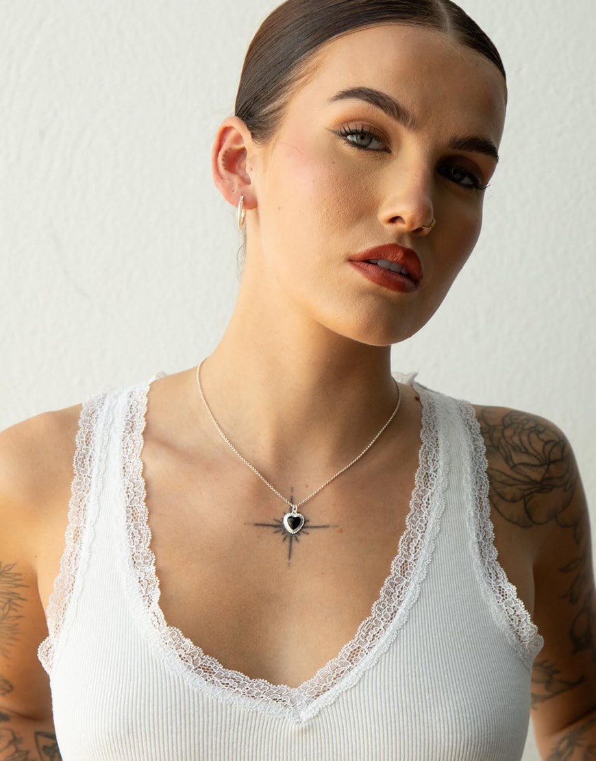 Sophie Floyd wearing a silver black heart pendant