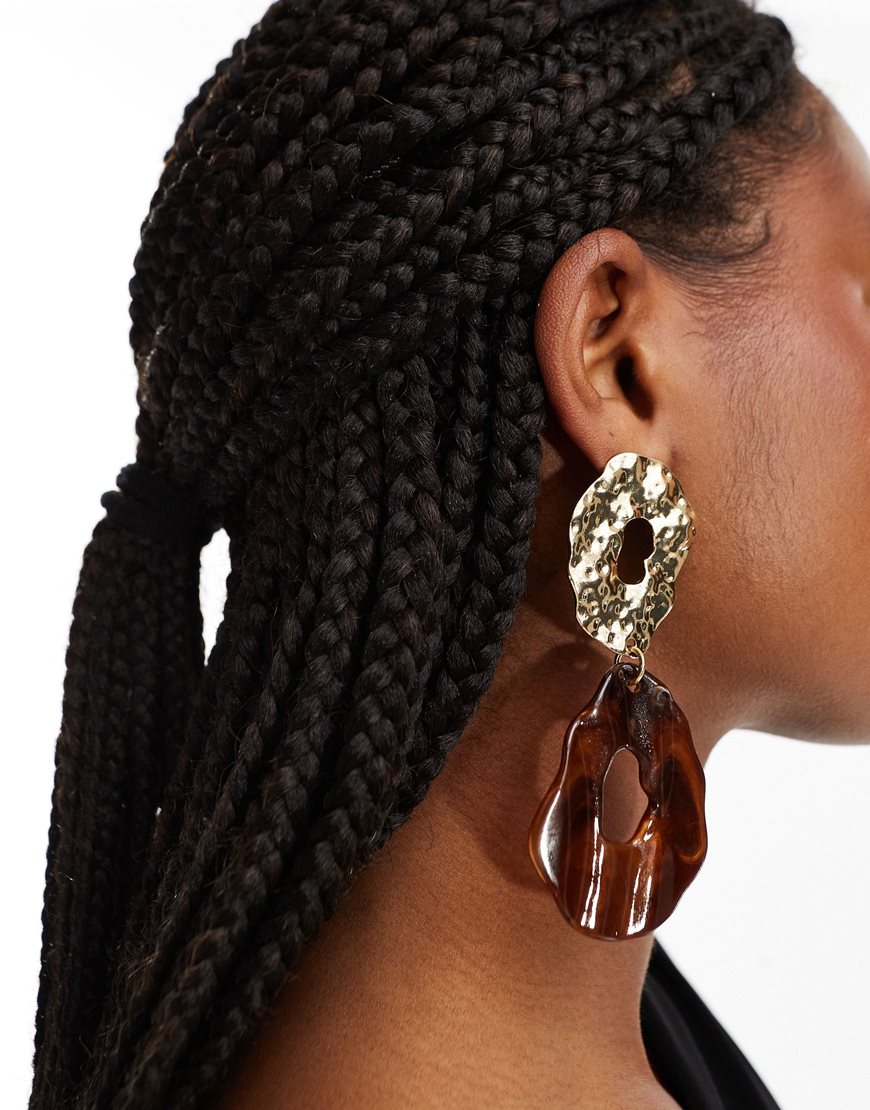 A woman wearing gold-tone and tortoiseshell earrings | ASOS Style Feed