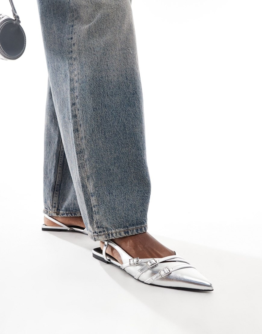 Woman wearing gray jeans and silver heels