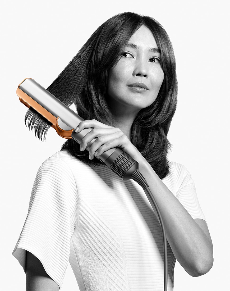 Woman using the Dyson Airstraight straightener