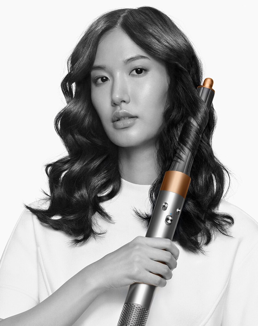 Model holding Dyson Airwrap