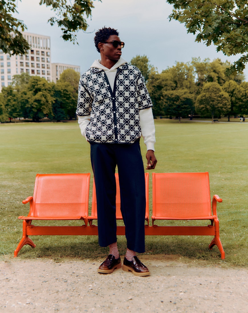 A man wearing a black and white cardigan in the park | ASOS Style Feed