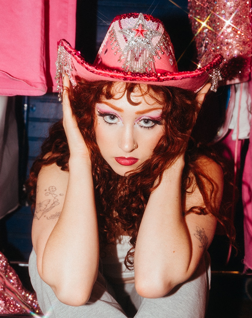 Chappell Roan wearing a pink glittery cowboy hat
