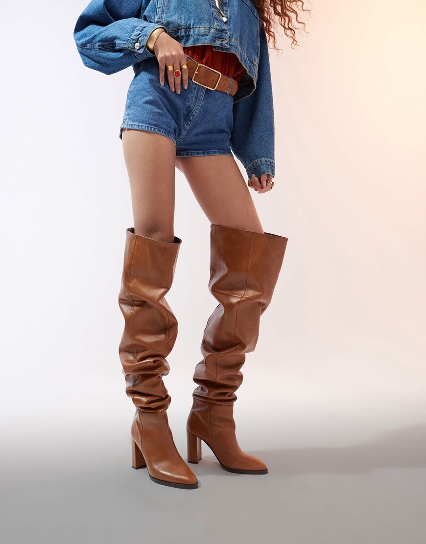 Model wearing tan over the knee boots