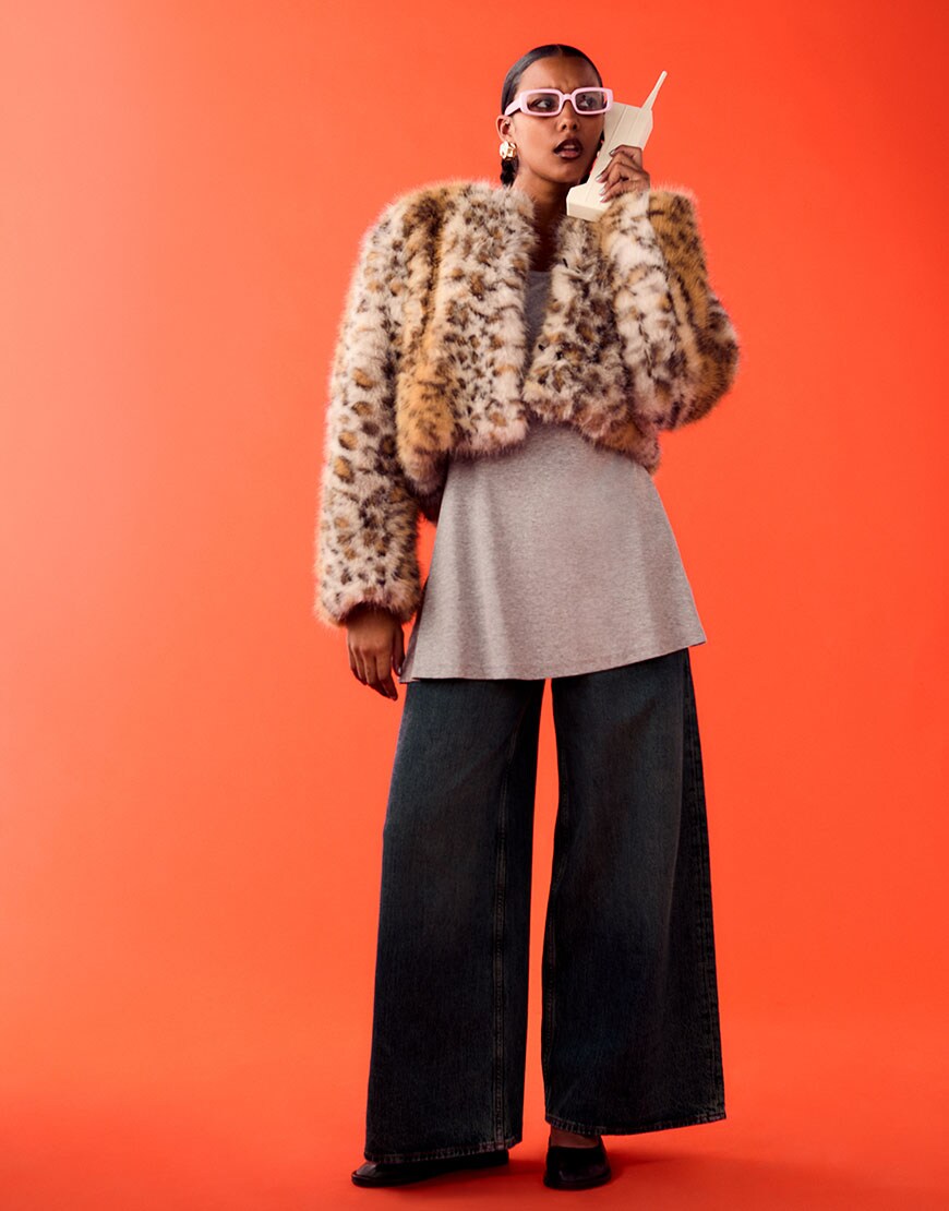 Woman on orange background wearing leopard faux fur coat and jeans | ASOS Style Feed