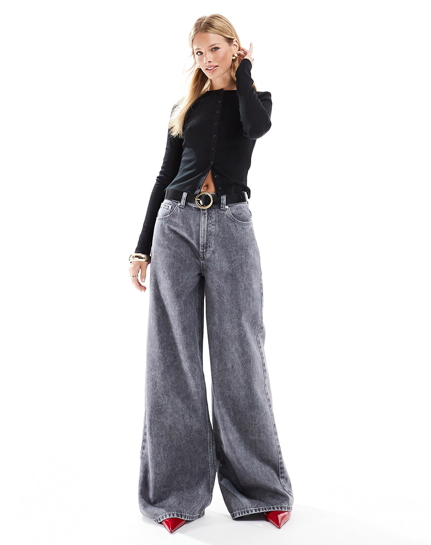 A woman wearing grey wide-leg jeans and a black top | ASOS Style Feed