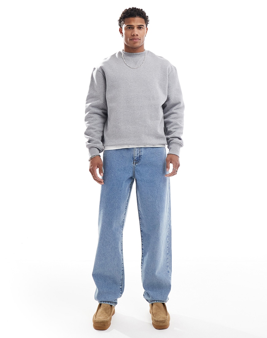 A man wearing light wash baggy jeans with a grey sweatshirt | ASOS Style Feed