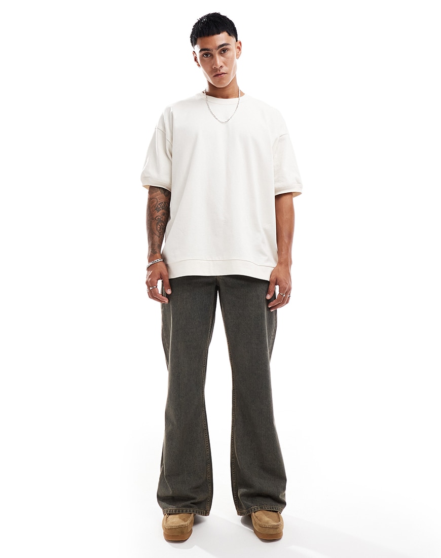 A man wearing dark grey wide flare jeans and a white t-shirt | ASOS Style Feed