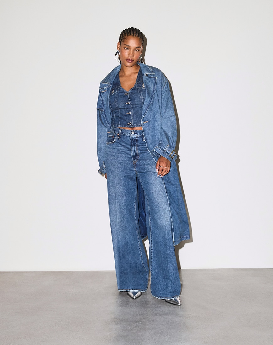 Model wearing Levi's Ribcage Wide Leg jeans with a denim coat and waistcoat