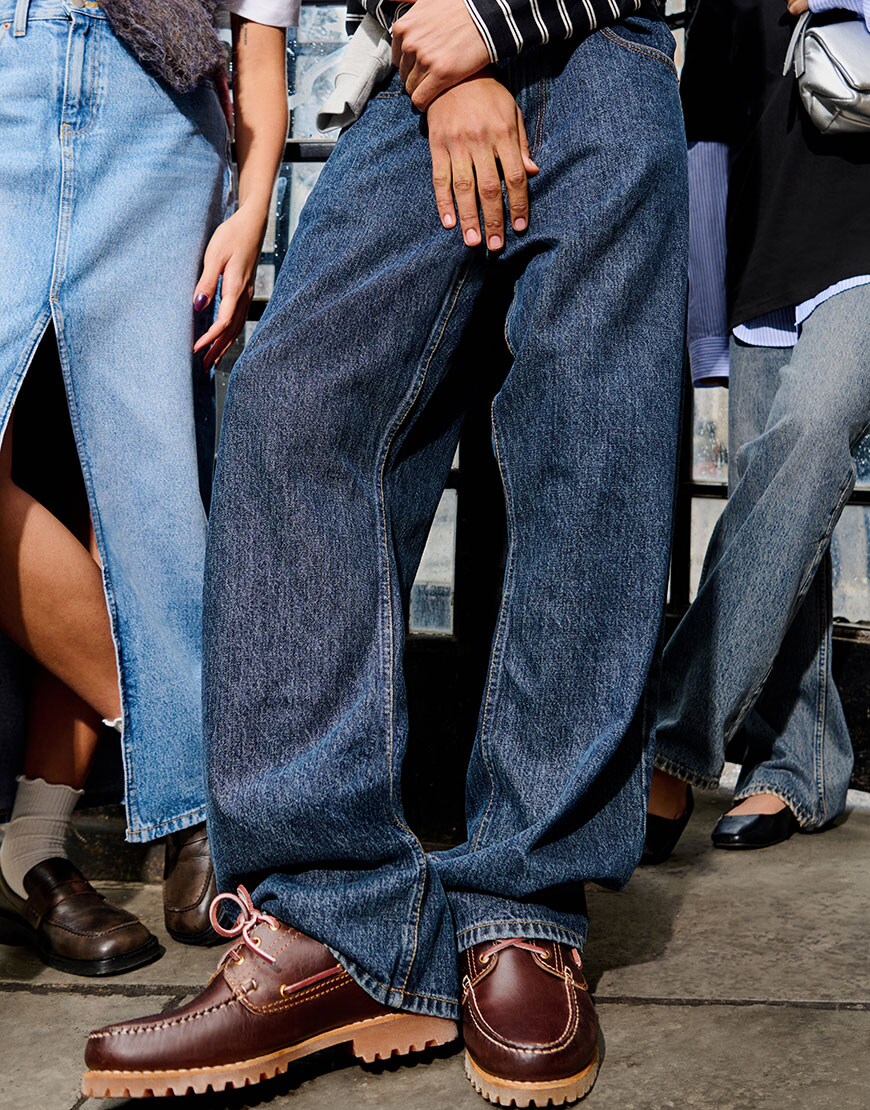 From left to right: blue denim skirt, baggy jeans with brown shoes, light blue baggy jeans