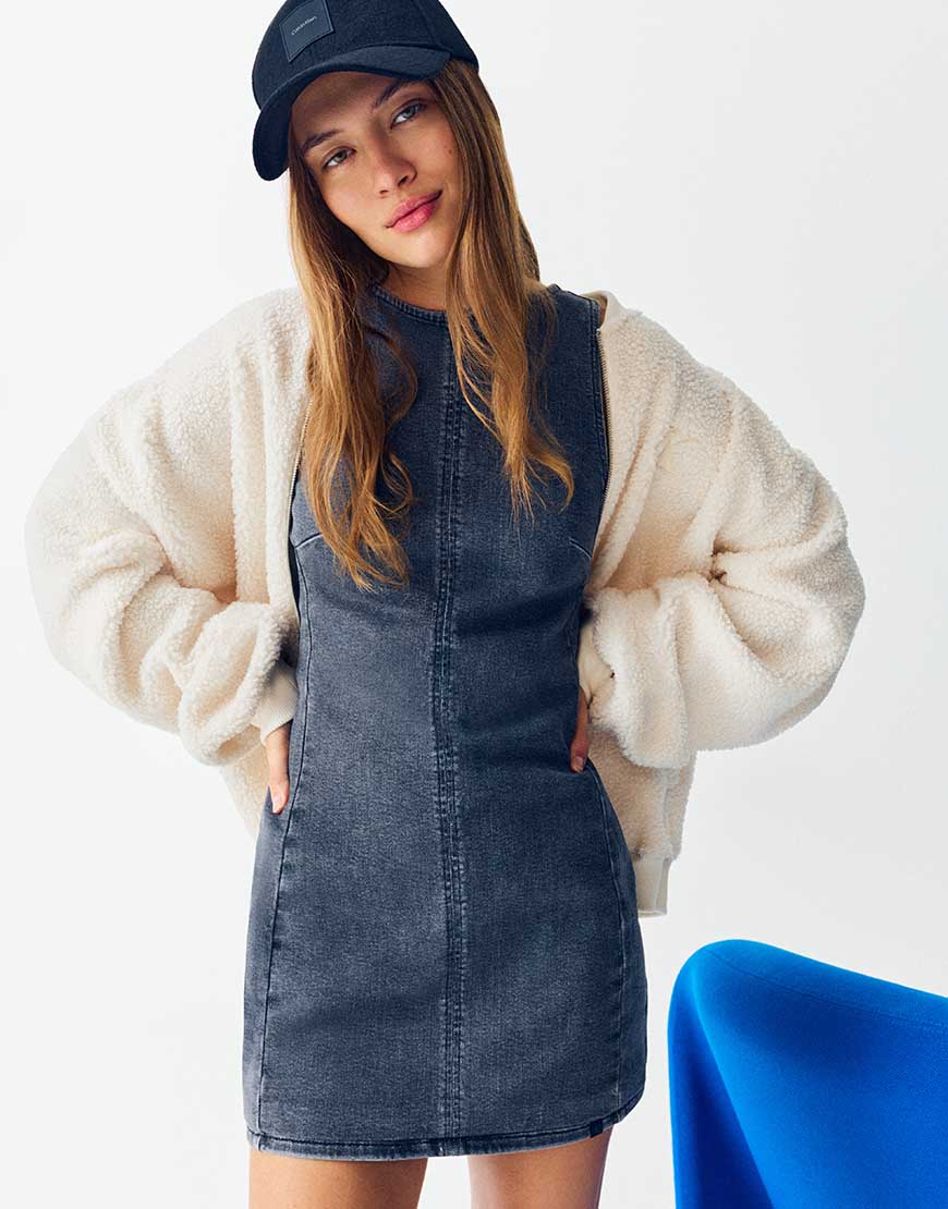 Model wearing Calvin Klein Jeans mini dress, white jacket and hat | ASOS Style Feed