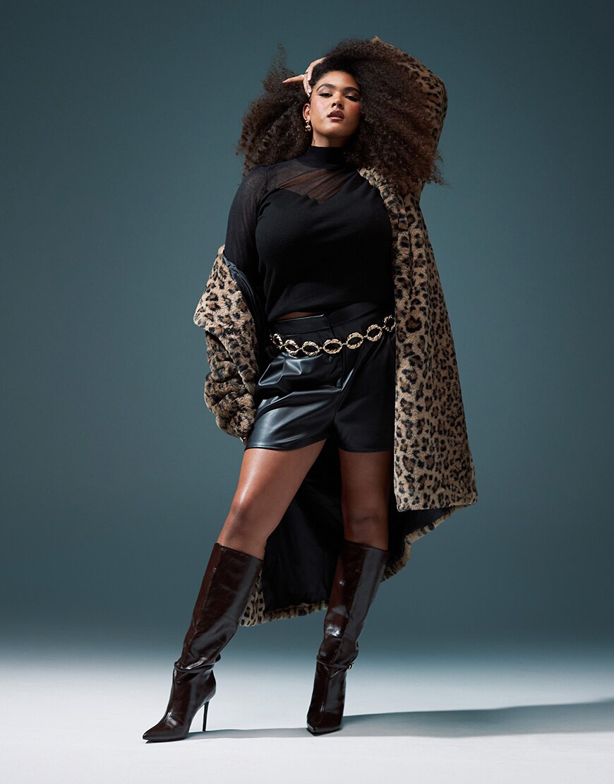 Model wearing black outfit with a cheetah print fur jacket