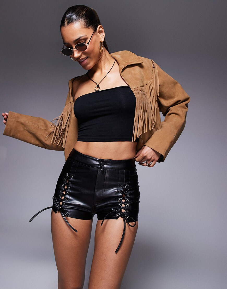 A model wearing leather-look lace up micro shorts