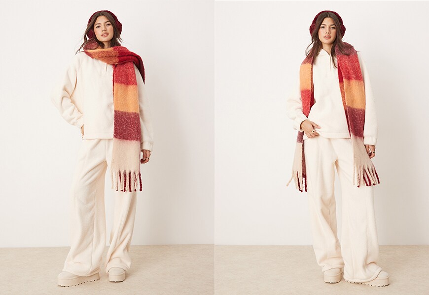 Model wearing cream Borg tracksuit set with red printed scarf