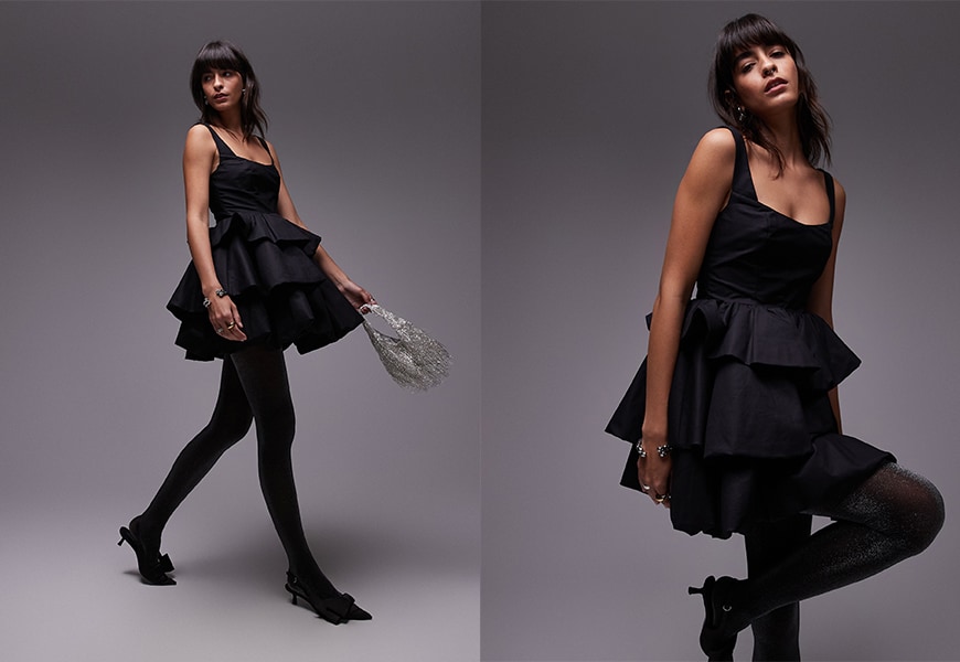 Model wearing black frilly mini dress
