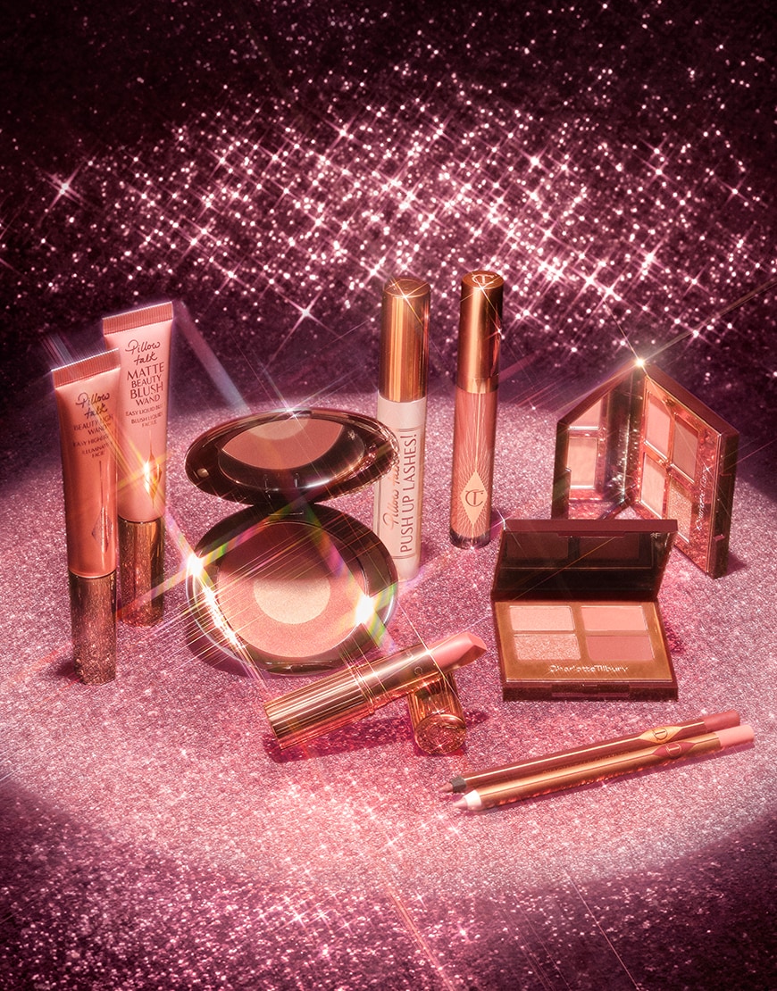 Charlotte Tilbury makeup products under a dazzling spotlight