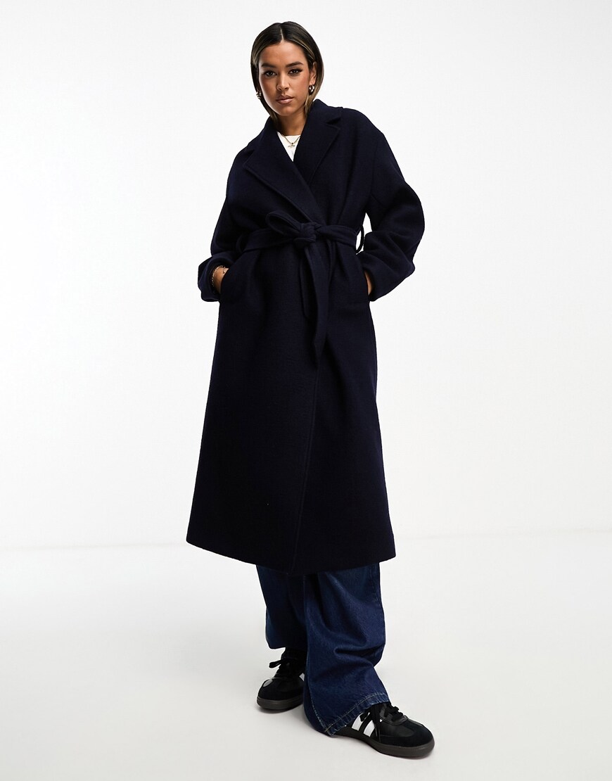 A woman wearing a belted wool coat | ASOS Style Feed