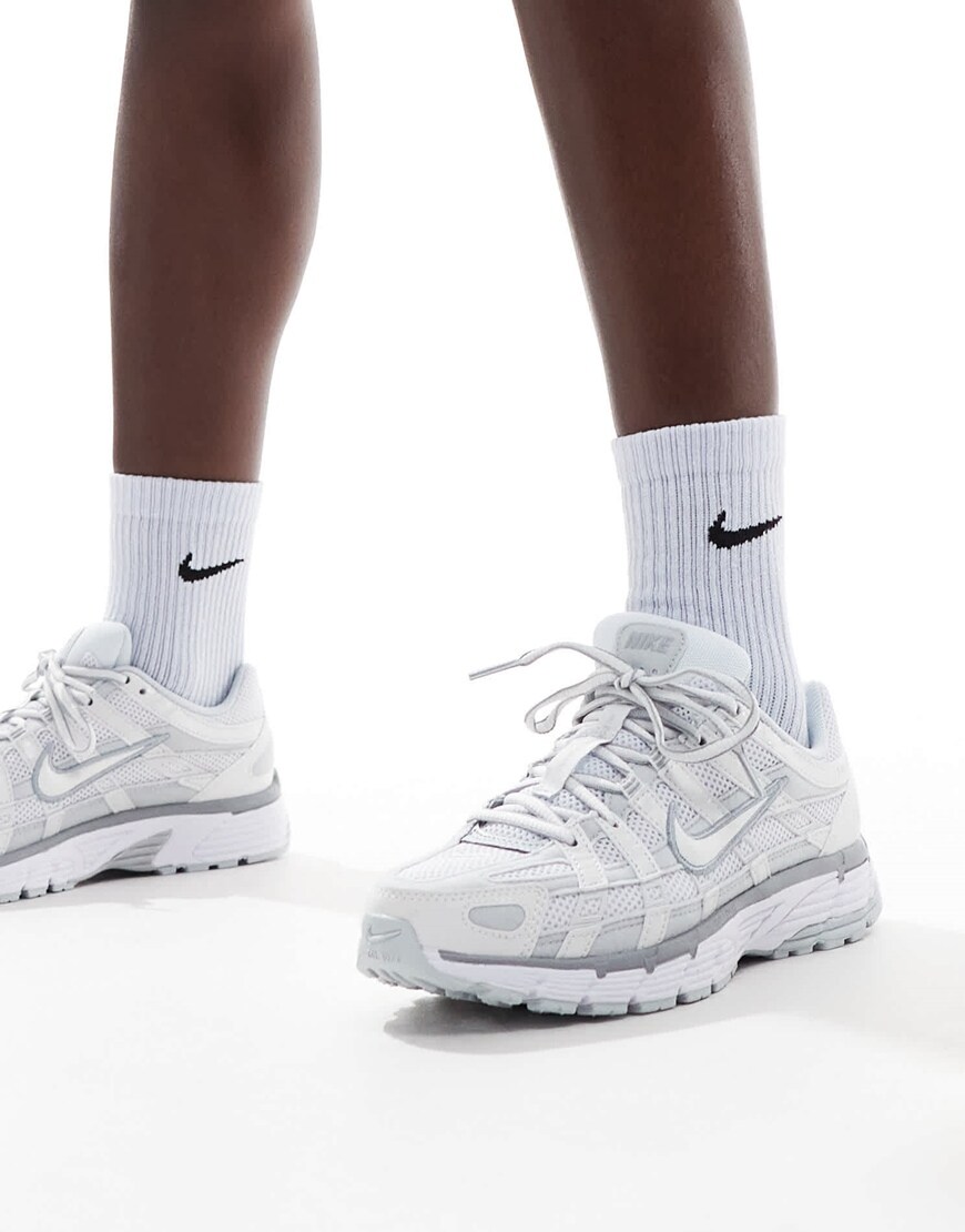 A woman wearing white and silver Nike sneakers | ASOS Style Feed