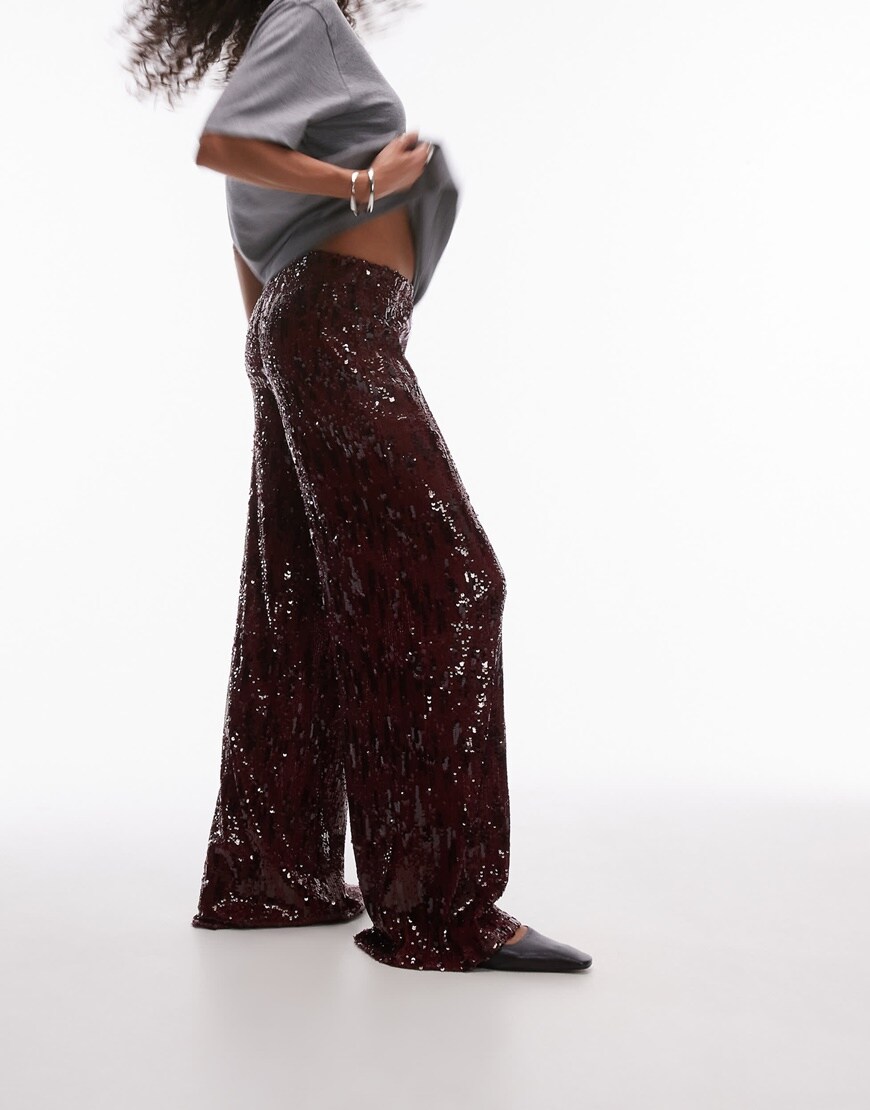 A woman wearing burgundy sequin trousers | ASOS Style Feed