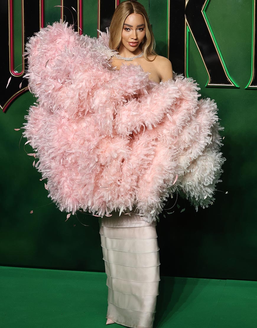 Munroe Bergdorf wearing a pink dress to the Wicked Premiere