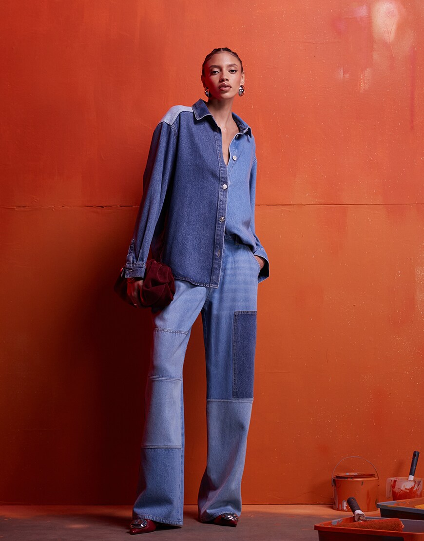 Model wearing denim co-ord set on an orange background