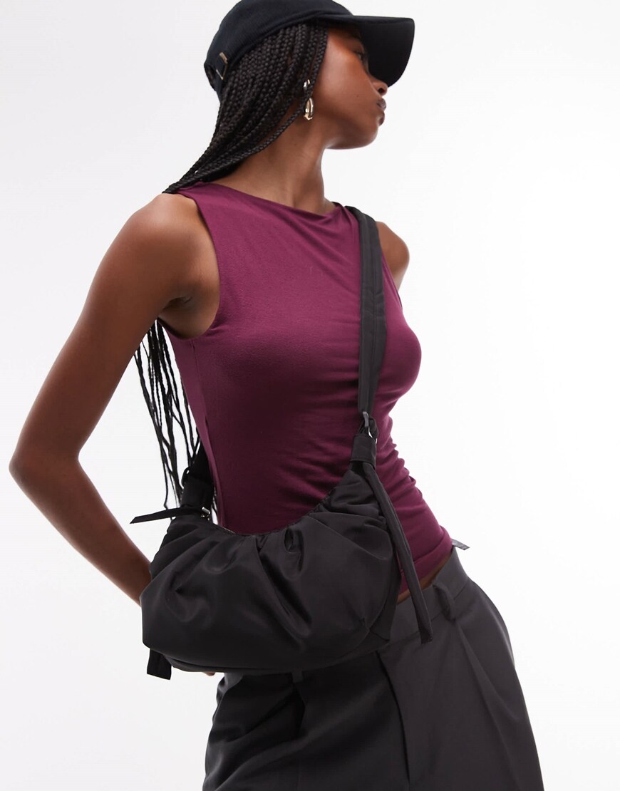 A model wearing a black cross body bag | ASOS Style Feed