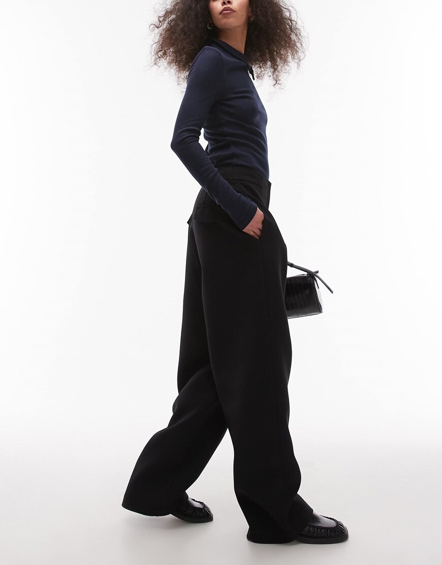 A model wearing black trousers | ASOS Style Feed