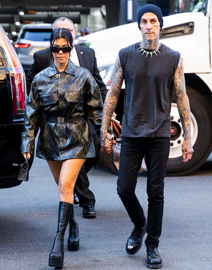 Kourtney Kardashian and Travis Barker walking across the road. | ASOS Style Feed