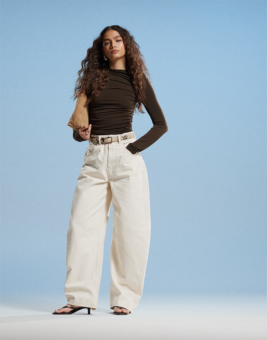 Model wearing white jeans and black top